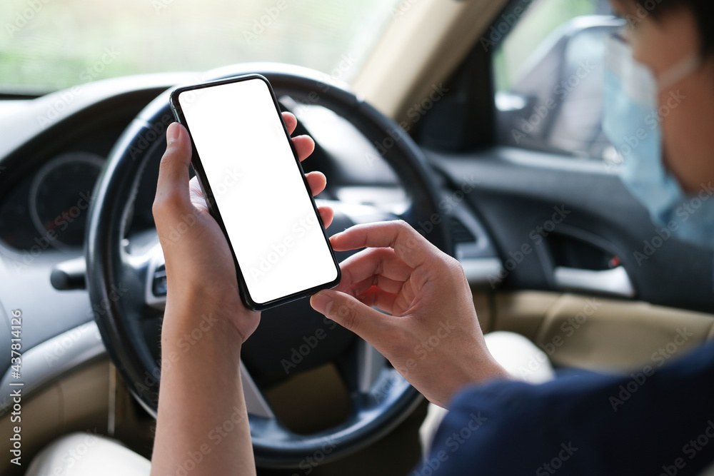 Cropped shot view The driver uses the phone while driving. Modern smart phone with round edges. Isolated screen for mockup. Car navigation display in background.
Cropped shot view The driver uses the phone while driving. Modern smart phone with round edges. Isolated screen for mockup. Car navigation display in background.