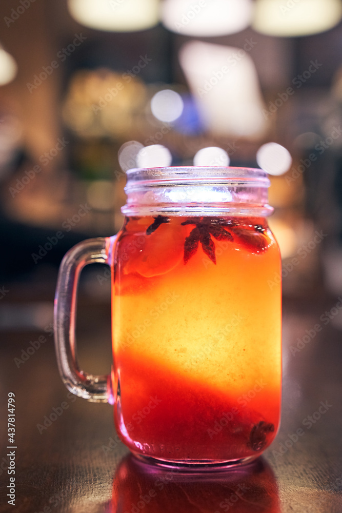 Christmas drink red non-alcoholic mulled wine with a straw on the background of the cafe interior, order for one