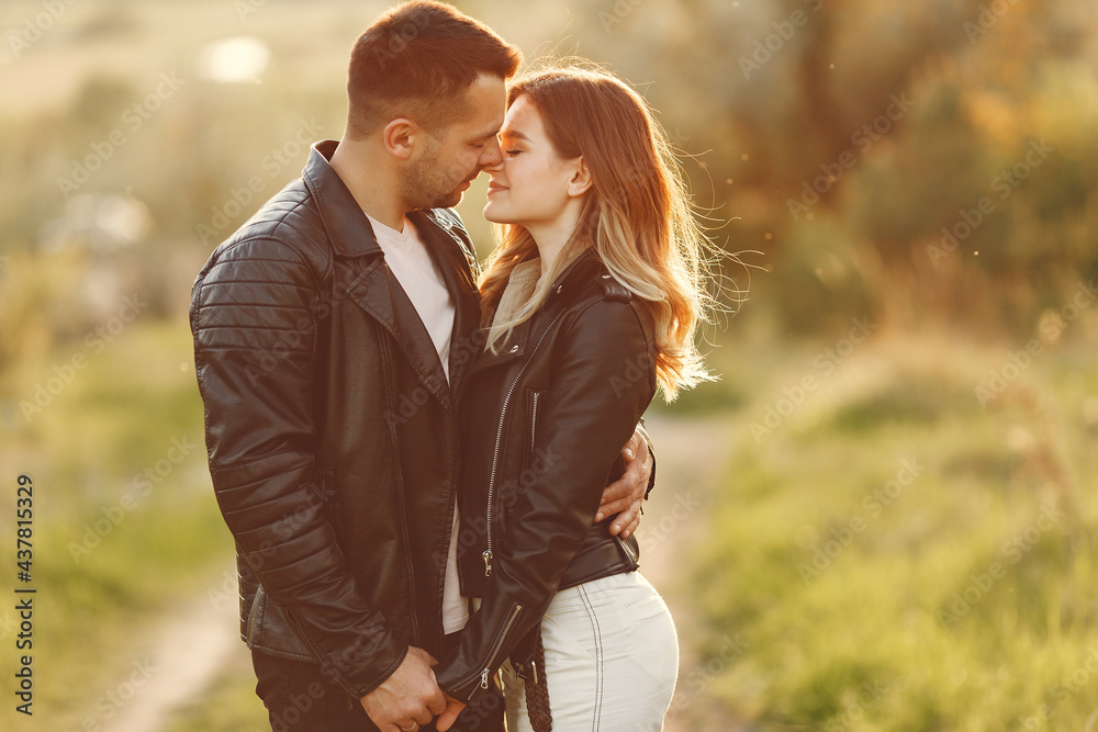 Beautiful couple spend time on a summer field Beautiful couple spend time on a summer field