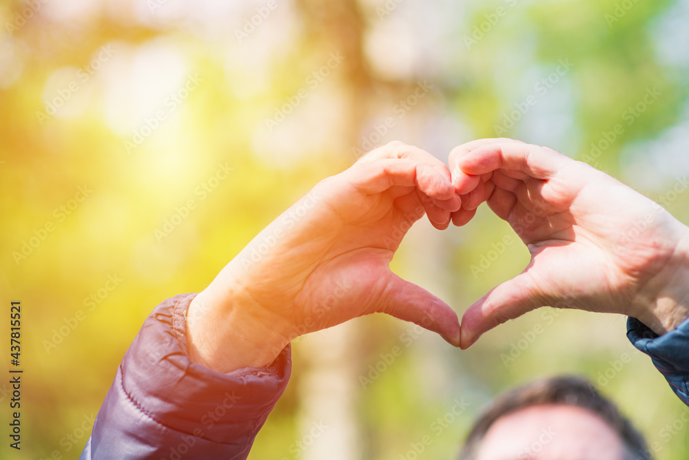Heart with hands outdoors on sunny day at forest, closeup Heart with hands outdoors on sunny day at forest, closeup