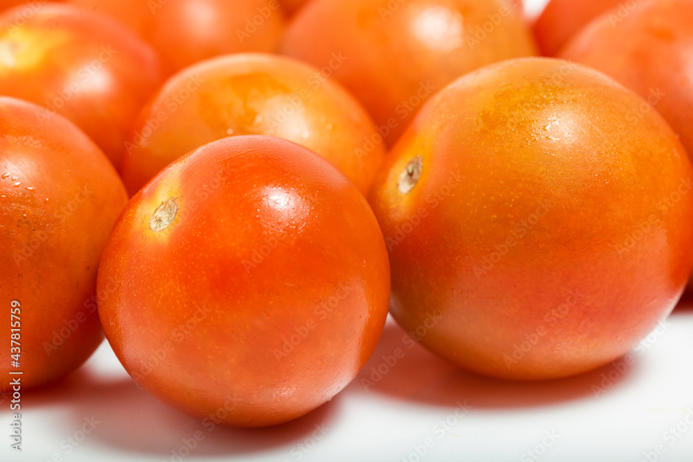 Tomato cherry close up isolated on white background. Macro photograpy.