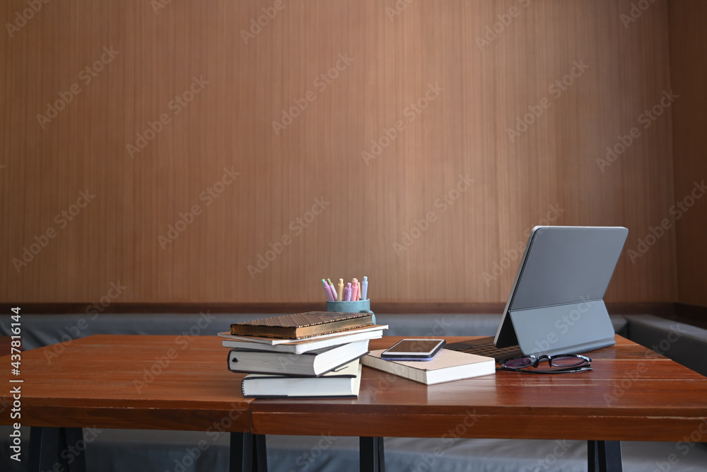 Mock up computer tablet, books, pencil holder, smart phone and glasses on wooden table. Mock up computer tablet, books, pencil holder, smart phone and glasses on wooden table.