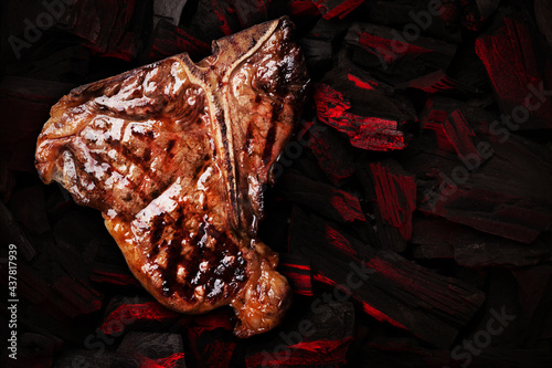 Grilled t-bone steak over hot coal photo