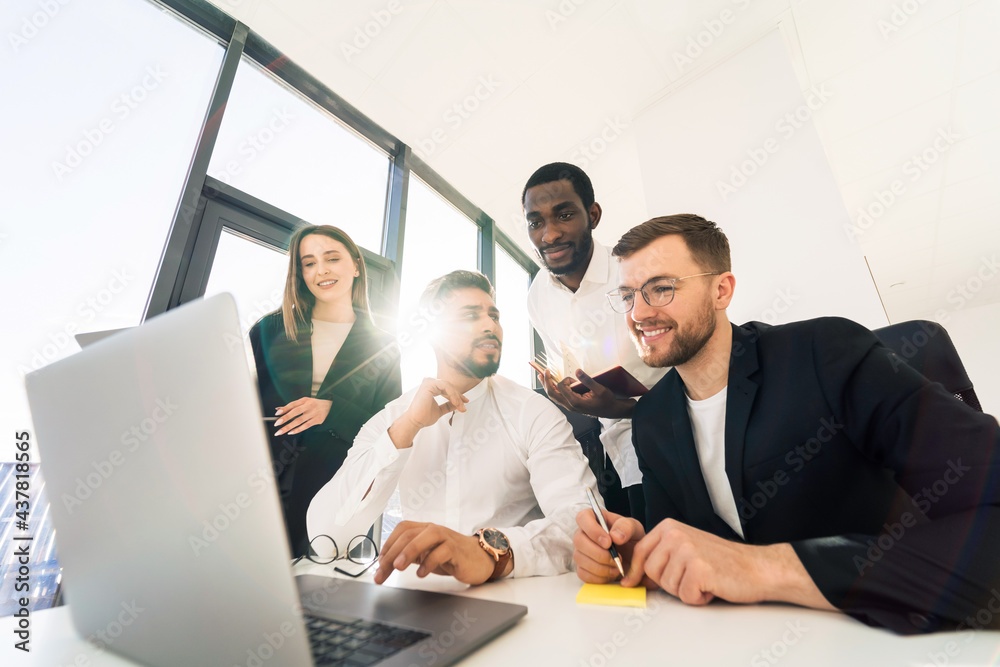 Group of young business people have meeting at laptop Group of young business people have meeting at laptop