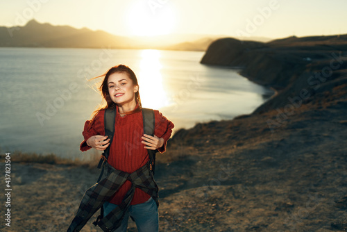 cheerful woman tourist with backpack travel freedom walk landscape