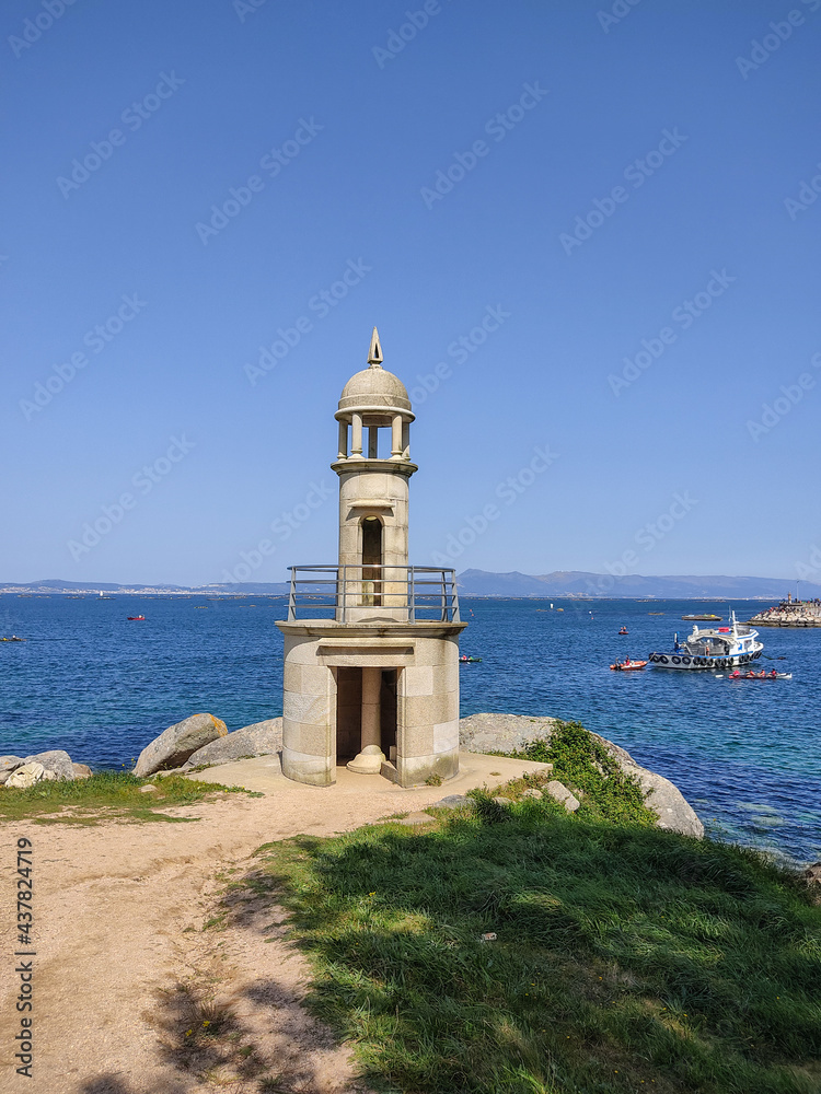lighthouse in the sea in summer