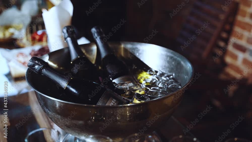 Three bottles of champagne in a bowl of ice