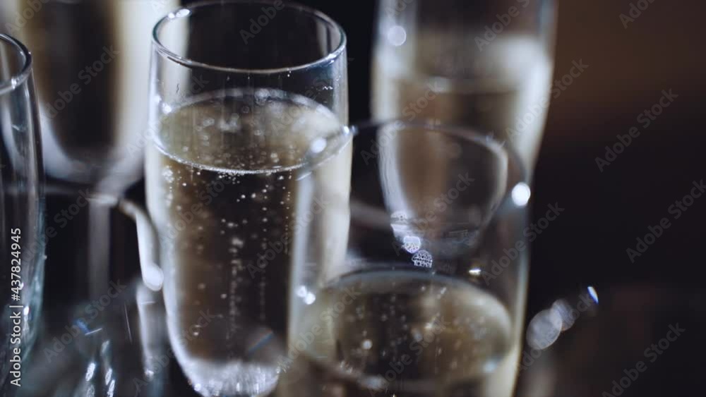Champagne bubbles in glasses in slow motion
