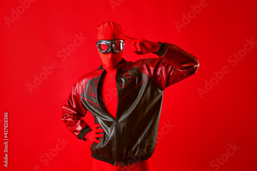 A funny super hero in a red leotard and protective glasses