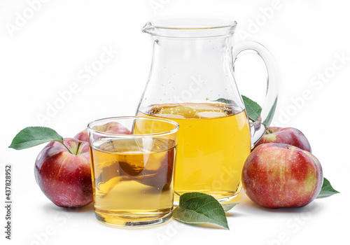 Glass and carafe of fresh apple juice and organic apples isolated on white background.