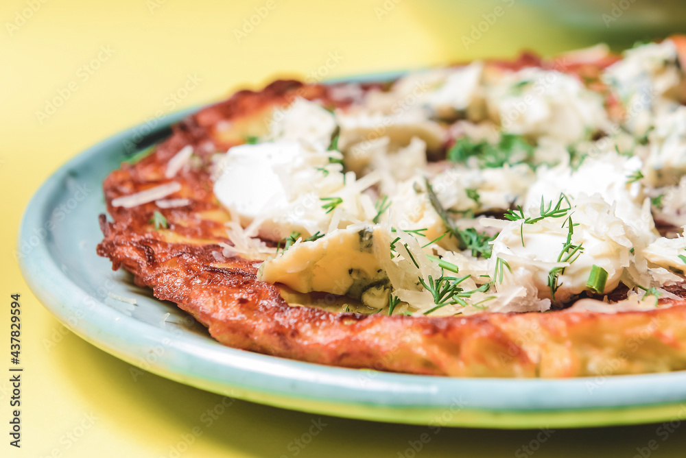 Healthy home-made vegetarian potato pizza. Delicious cheese and fresh greenery on a potato pancake. Healthy home-made vegetarian potato pizza. Delicious cheese and fresh greenery on a potato pancake.