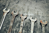 Spanners on steel surface. Old rusty wrenches for maintenance. Mechanic hardware tools to fix. Technical tools background