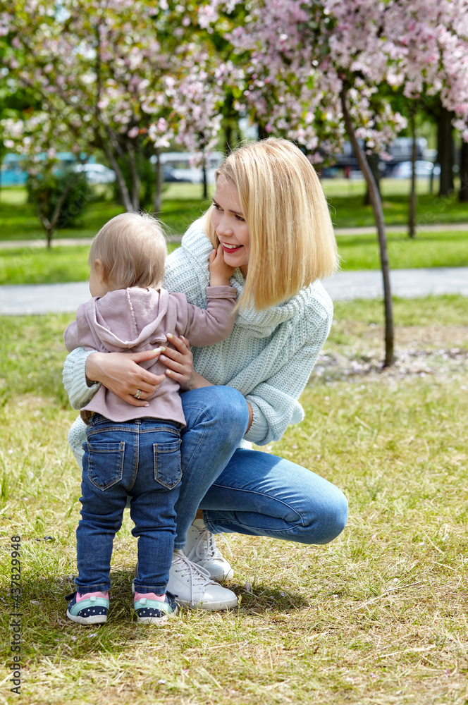 Mom and daughter on nature walk at spring park. Little girl and mother have a good time on weekend activity Mom and daughter on nature walk at spring park. Little girl and mother have a good time on weekend activity