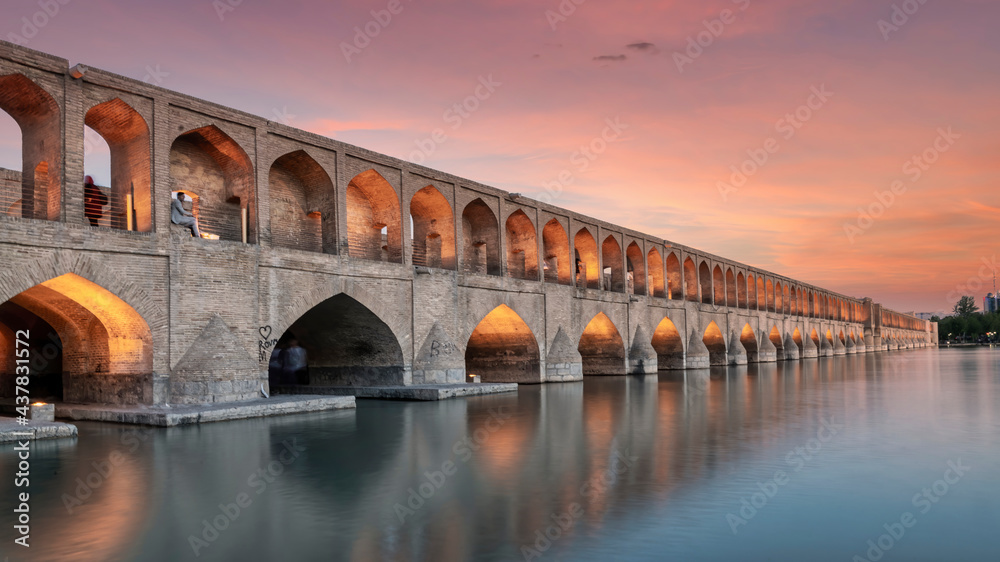 Isfahan, Iran - May 2019: Allahverdi Khan Bridge also known as Si-o-se-pol Bridge during sunset. One of the oldest bridges of Isfahan. Long expsore shot, blurring is done on purpose