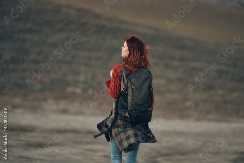 woman in the mountains with a backpack on her shoulders back view travel tourism rock