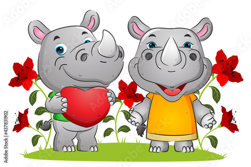 The couple of happy rhino expressing love on the valentine day in the garden