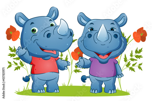 The couple of happy rhino waving the hand and giving the happy smile in the garden