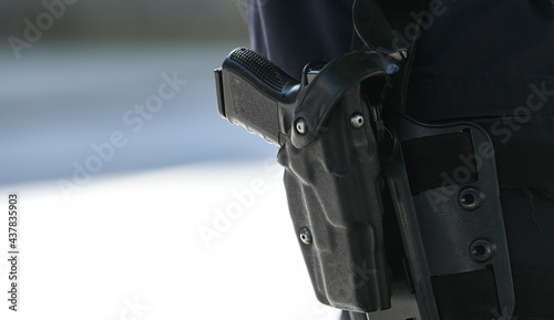 Law enforcement. Close up view of a policeman's gun equipment. Protection during an event.