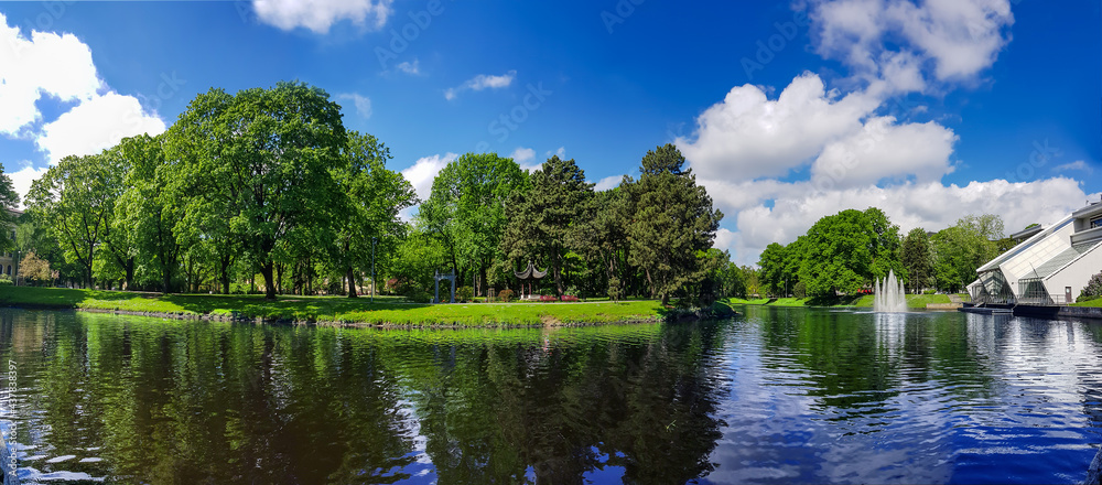 Panorama of the Riga Canal against the background of beautiful Kronvalda Park on summer day in Riga, Latvia.