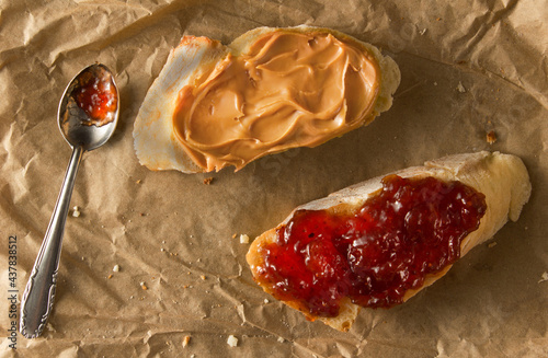 two sandwiches with penaut butter and strawberry jam photo