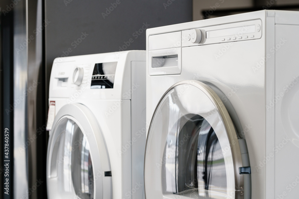 New washing machine in a home appliances store New washing machine in a home appliances store