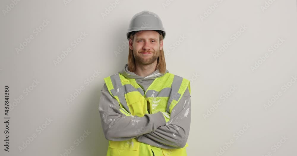 Bearded serious male industrial worker keeps arms folded wears protective helmet and uniform ready for building or reconstruction isolated over white background. Experienced foreman in workwear Bearded serious male industrial worker keeps arms folded wears protective helmet and uniform ready for building or reconstruction isolated over white background. Experienced foreman in workwear
