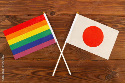 Photography Rainbow flag LGBT and flag of Japan on brown wood planks background
