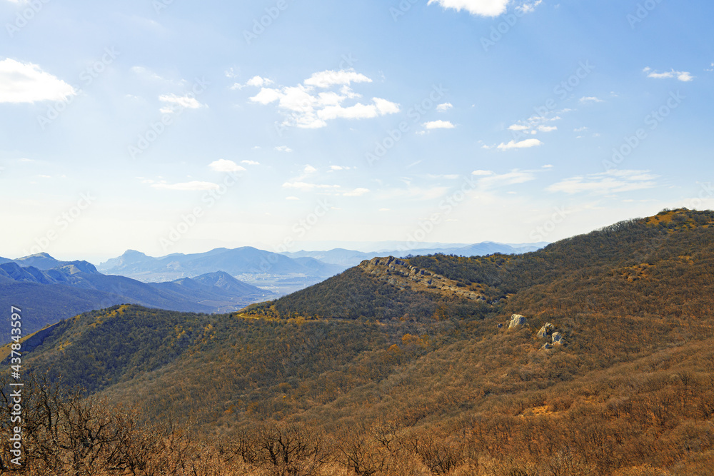 Mountains landscape against blue sky with clouds on sunny day