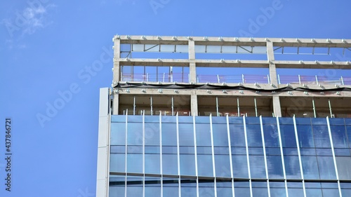 High-rise building under construction. Modern office building. Sunrise.