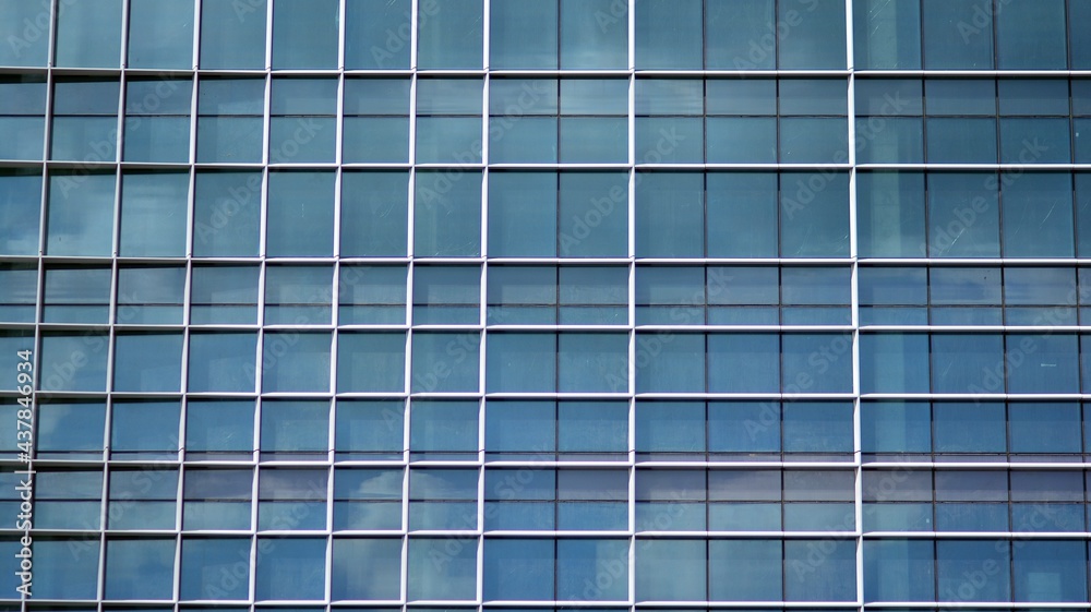 Modern architecture with sun ray. Glass and steel facade on a bright sunny day with sunbeams on the blue sky. Economy, finances, business activity concept. Modern architecture with sun ray. Glass and steel facade on a bright sunny day with sunbeams on the blue sky. Economy, finances, business activity concept.