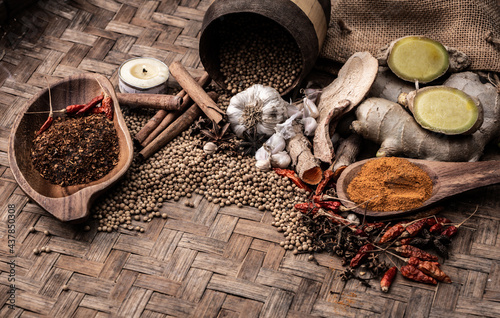 Top view of colourful spices in wooden tray. Asian popular cooking ingredients, dry hot healthy cook herbs. view form above and copy space background. photo