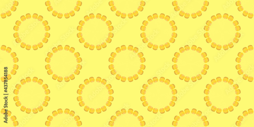 yellow candies are laid out in circles on a seamless banner. Picture for wrapping paper or ceramic tiles