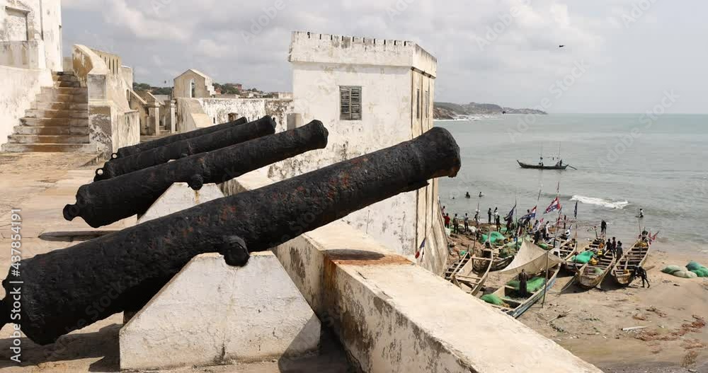 Cape Coast Ghana castle canon over fishing village. Cape Coast Castle is one of forty slave castles, or forts, built on the Gold Coast of West Africa, now Ghana by European traders. Cape Coast Ghana castle canon over fishing village. Cape Coast Castle is one of forty slave castles, or forts, built on the Gold Coast of West Africa, now Ghana by European traders.