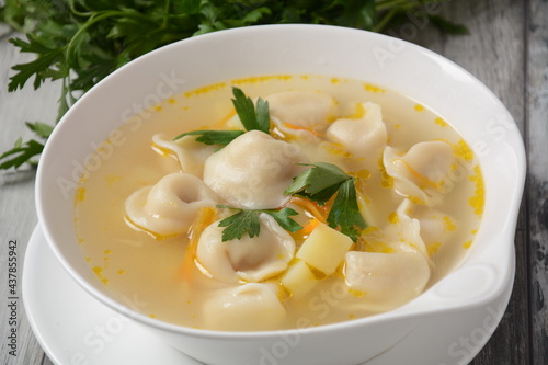 Soup with pelmeni (russian dumplings). Soup with meat dumplings, potatoes and other vegetables