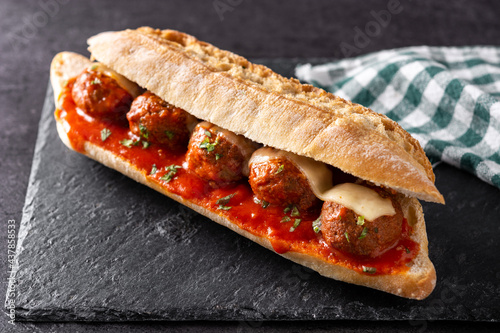 Meatball sub sandwich on black stone photo