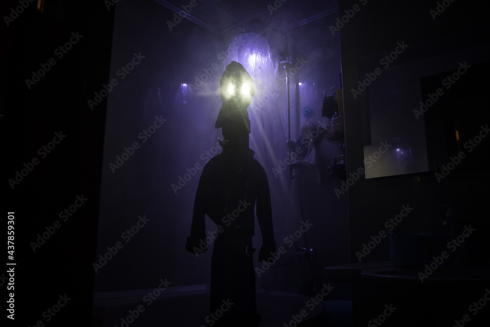 Halloween concept. Horror silhouette of person in shower cabin. Killer maniac inside bathroom with glowing lights.