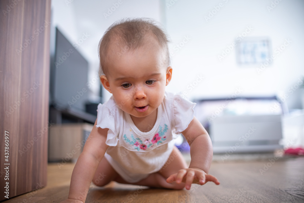 Portrait of child on all fours in bright indoors. Lifestyle background Portrait of child on all fours in bright indoors. Lifestyle background