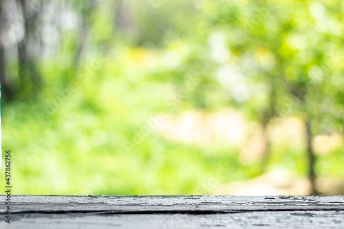 abstract blurred background. Wooden window sill against the background of a defocused garden with trees