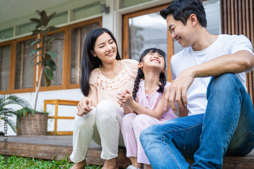 Happy family, Parent look to young kid girl daughter in garden at home Happy family, Parent look to young kid girl daughter in garden at home