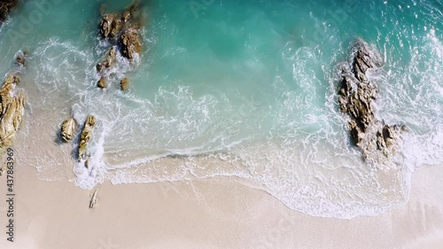 4K Aerial drone top down view bird eye view of sea blue waves break on rock and sand. Beautiful of sea water wave come to beach. Phuket Thailand tropical beach