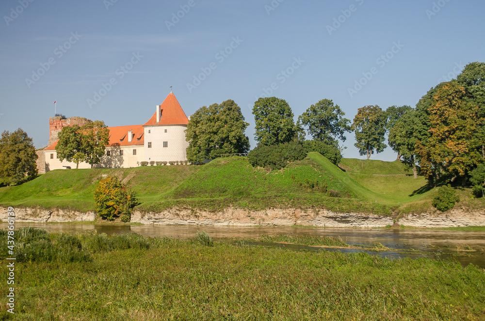 Bauska city castle in Latvia up in the hill. Sunny autumn day. Bauska city castle in Latvia up in the hill. Sunny autumn day.