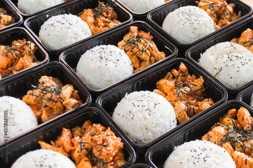 Korean food lunch boxes in plastic packages, Rice and spicy Korean pork stir-fry.
