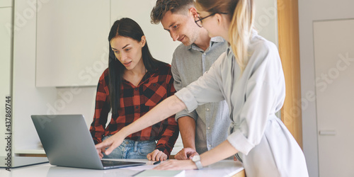 Successful woman architect presenting building project to the clients at laptop