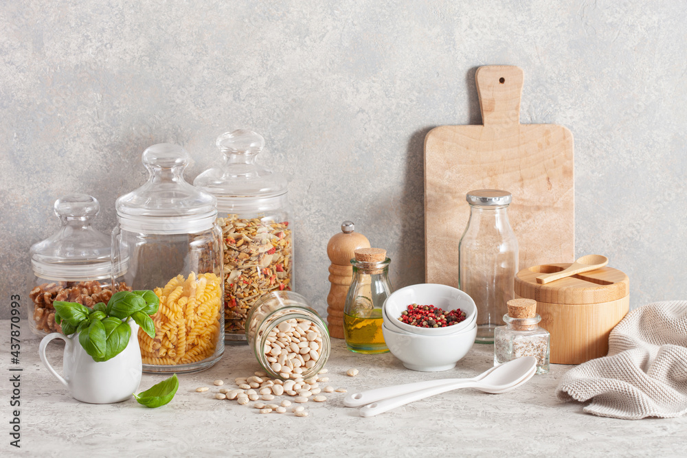 kitchen utensils on modern simple counter, kitchenware jars with dry ingredients bowls kitchen utensils on modern simple counter, kitchenware jars with dry ingredients bowls