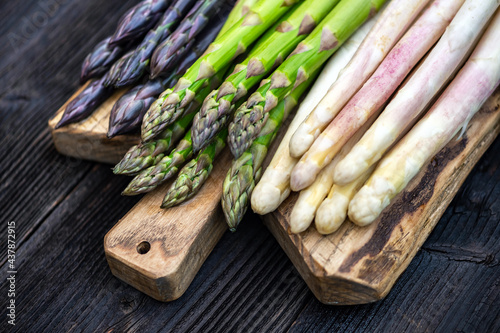 Green, purple and white asparagus sprouts