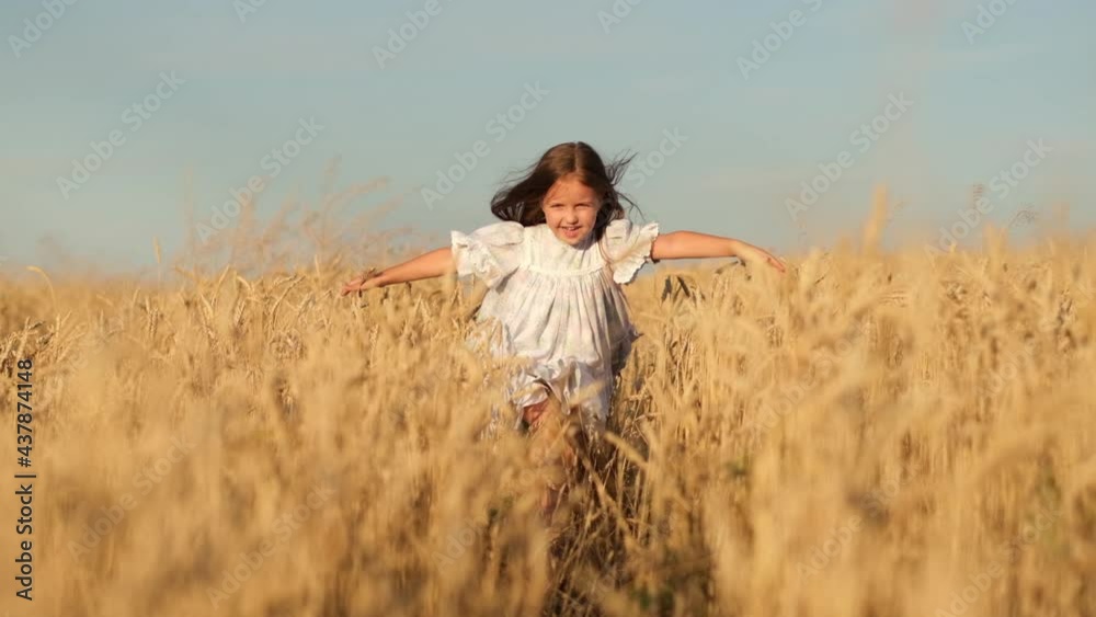 Beautiful girl with long blond hair running through a wheat field smiling. Cute happy baby in a straw hat running in a barley meadow on a sunny day. Close up slow motion Beautiful girl with long blond hair running through a wheat field smiling. Cute happy baby in a straw hat running in a barley meadow on a sunny day. Close up slow motion