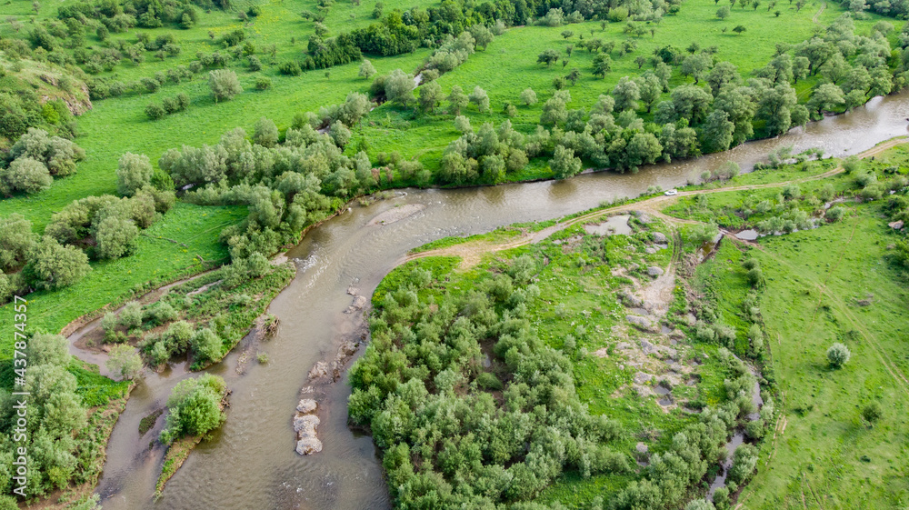 drone shot of a green forest and river