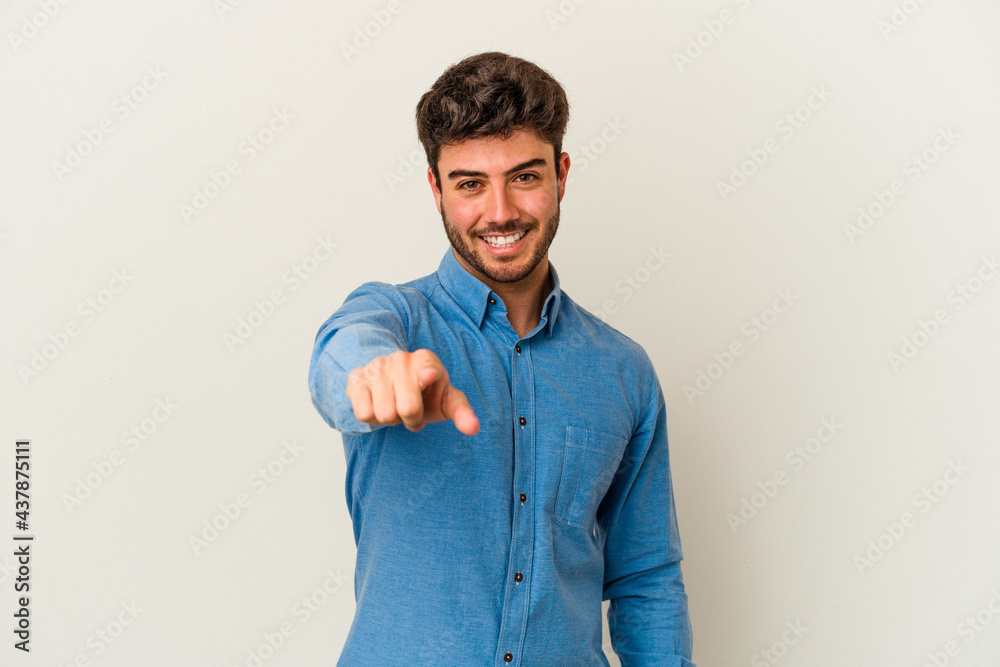 Fototapeta premium Young caucasian man isolated on white background pointing to front with fingers.