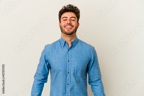 Young caucasian man isolated on white background laughs and closes eyes, feels relaxed and happy.