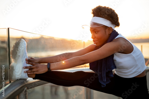 Sporty woman training outdoors. Young african woman in sportswear..